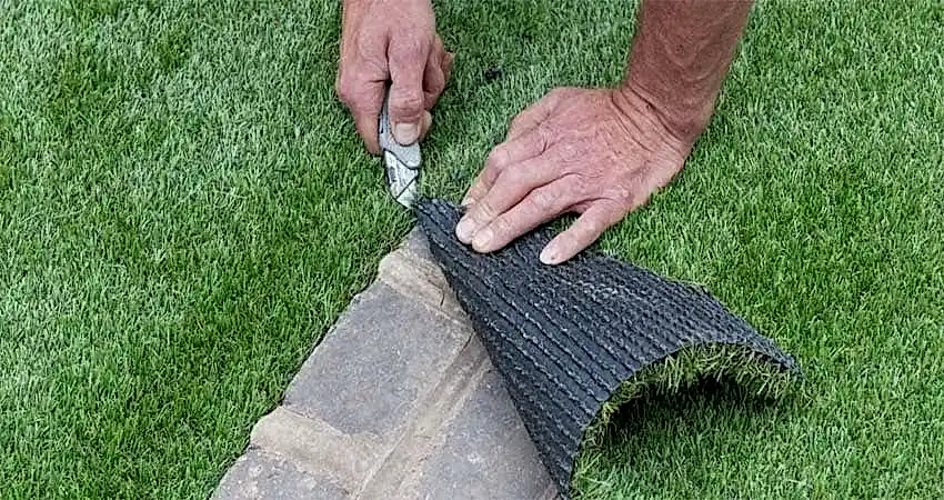artificial grass being trimmed